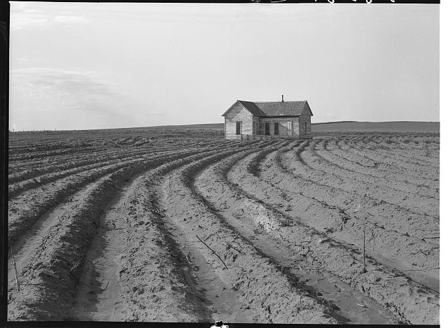 Barn surrounded by plowed-out field