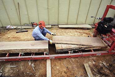 Photo of Bjorn Karlsson pulling wood from a sawmill